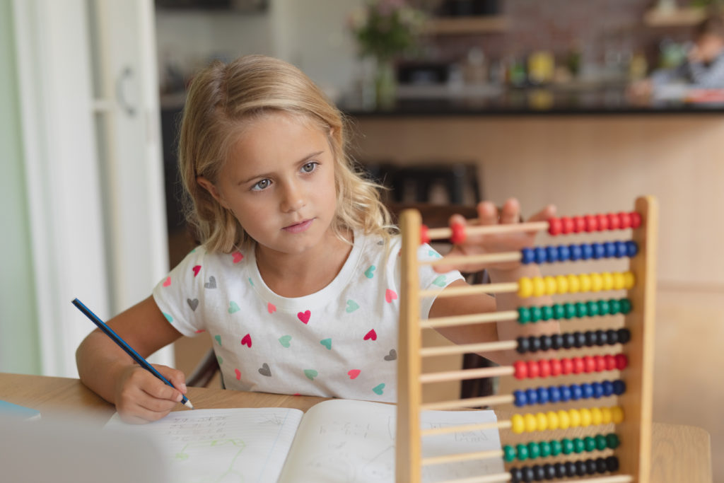 girl-doing-homework-at-table-in-a-comfortable-home-4459065 (1)